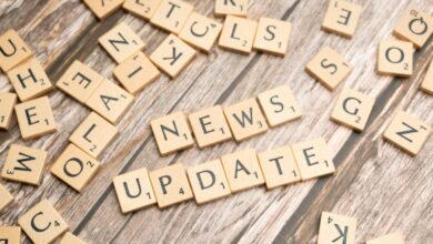scrabble tiles spelling news update on a wooden table