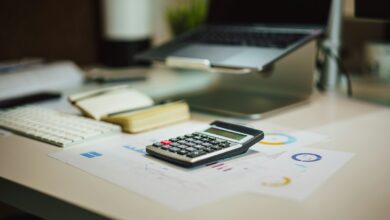 a calculator sitting on top of a table next to a laptop