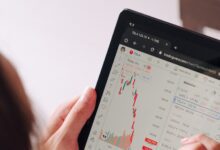 a woman holding a tablet with a chart on it