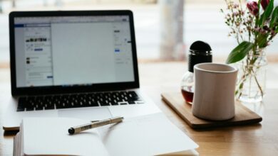 macbook pro near white open book