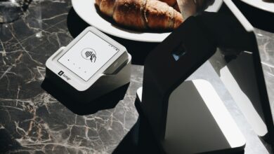 a table topped with plates of food and a laptop