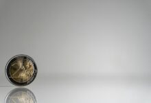 a close up of a coin on a reflective surface