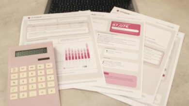 bills, calculator, and a laptop: financial tasks underway.