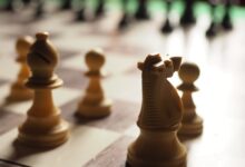 brown chess piece on chess board