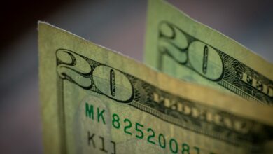 two stacks of twenty dollar bills sitting on top of each other