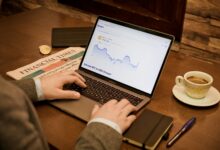 a person typing on a laptop on a table