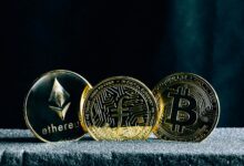 three bitcoins sitting on top of a table